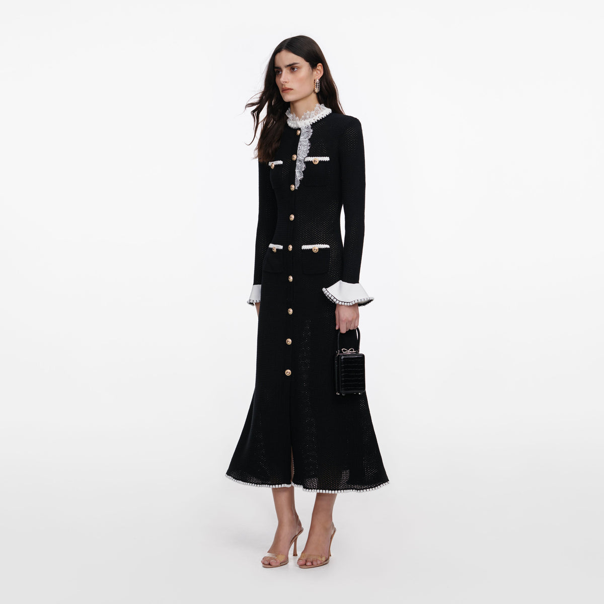 Side view of a woman wearing the Black Lace Trim Knit Midi Dress