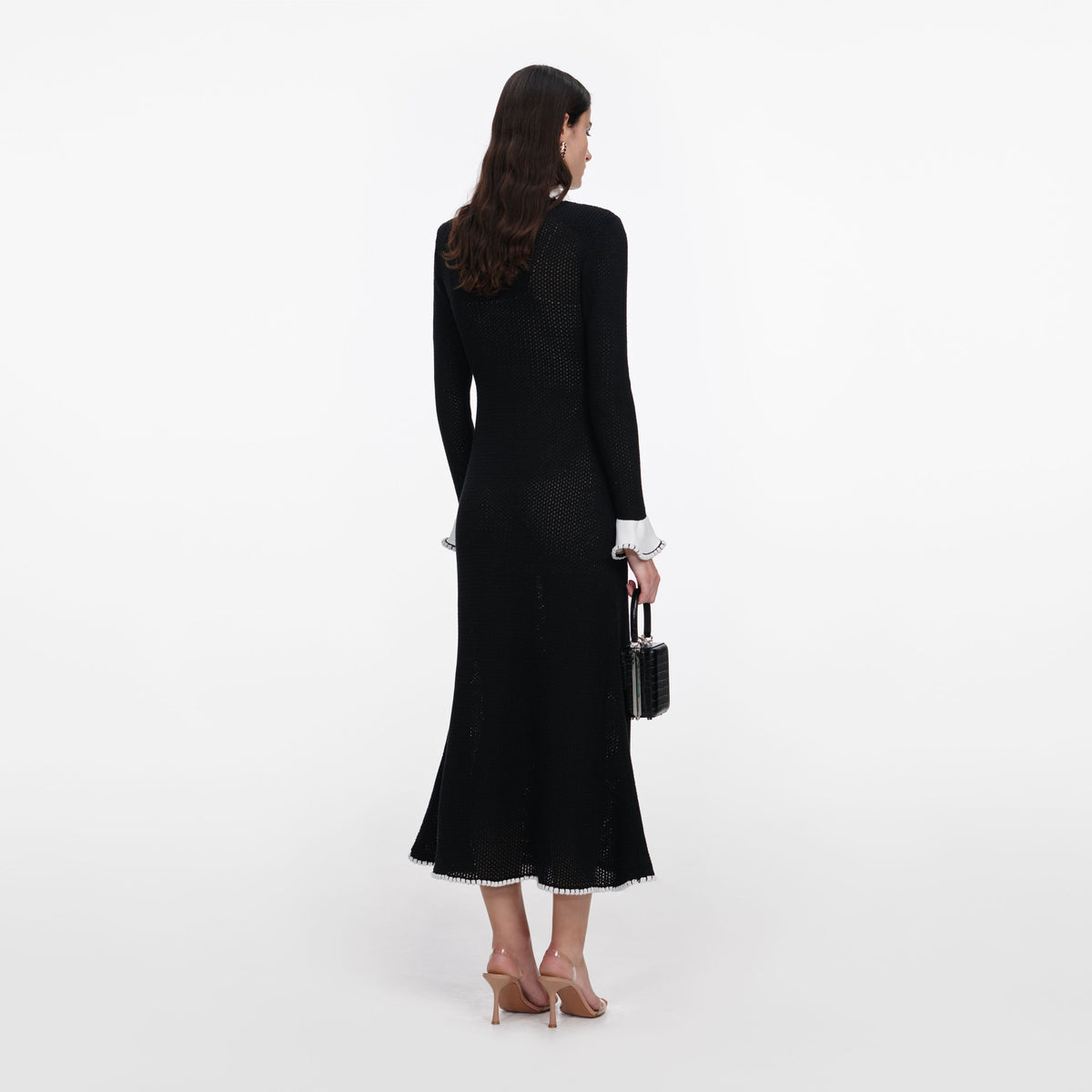 Back view of a woman wearing the Black Lace Trim Knit Midi Dress